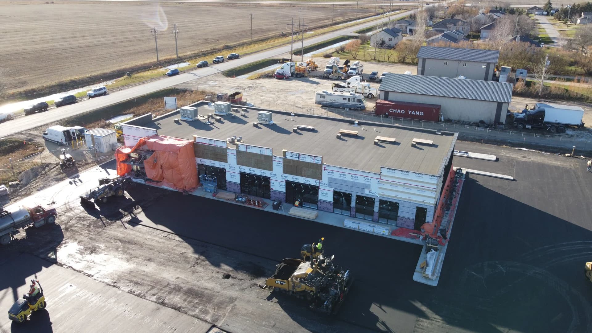 Aerial view of the Stony Mountain commercial rental units, showing storefront construction and parking lot paving